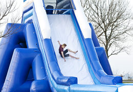 Monster slide 11 meters high and 54 meters long with a double staircase and wide slide. Order inflatable slides now online at JB Inflatables UK