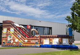 Mega inflatable slide in Pirates world theme with 3D obstacles for children. Buy inflatable slides now online at JB Inflatables UK