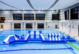 Slide swimming pool adventure run blue/white 16m with challenging obstacle objects and round slide for both young and old. Buy inflatable water attractions online now at JB Inflatables UK