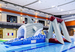 Airtight inflatable shark play island with a vine, climbing tower, round slide and obstacles for both young and old. Order inflatable water attractions now online at JB Inflatables UK