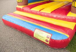 Standard bounce houses in striking colors and with a large 3D object of a monkey on top, for sale for children. Buy bounce houses online at JB Inflatables UK