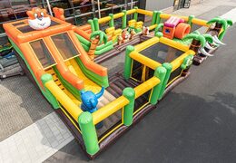 World jungle bouncy castle with multiple slides and all kinds of obstacles with prints that match the theme for kids. Buy bouncy castles online at JB Inflatables UK