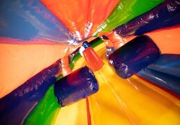 Order a circus crawl tunnel bouncer with obstacles, a climbing slope and a slide for kids. Buy bouncers online at JB Inflatables UK