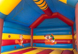 Big super bounce house covered with cheerful animations in monkey theme for children. Order bounce houses online at JB Inflatables UK