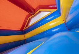 Order an inflatable bouncy castle with slide in a rollercoaster theme for children