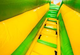 Climbing on bouncy castle in cheerful yellow and green colors