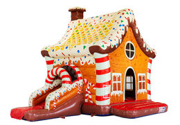 Indoor bouncy castle with slide decoration resembling a gingerbread house, red white brown