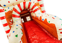 Red, white, and brown slide of Multifun bouncy castle in gingerbread theme