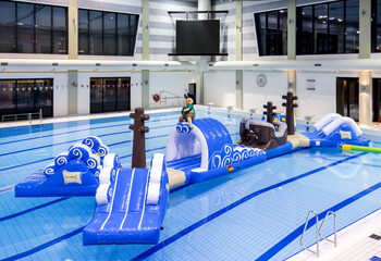Order double inflatable 16 meter long pirate run swimming pool obstacle course in a unique design with funny 3D objects and no less than 2 slides for kids. Buy inflatable obstacle courses online now at JB Inflatables UK