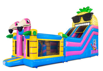 Mega bouncy castle with slide in a tropical theme for the summer