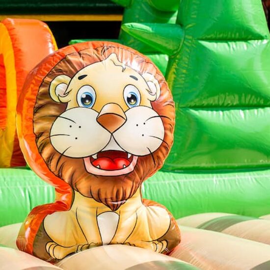 Mega inflatable jungle bouncer with slides, 3D objects, crawl tunnel and climbing tower for children. Order bouncers online at JB Inflatables UK