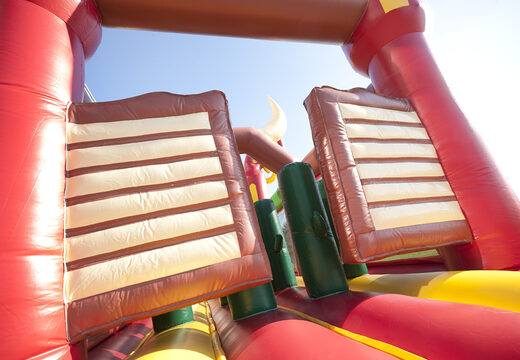 Order an inflatable 17 meter wide obstacle course in a cowboy theme with 7 game elements and colorful objects for kids. Buy inflatable obstacle courses online now at JB Inflatables UK