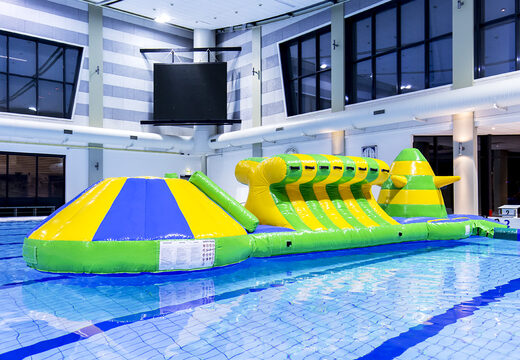 Adventure run green/blue 10m inflatable swimming pool with challenging obstacle objects and round slide for both young and old. Order inflatable pool games now online at JB Inflatables UK