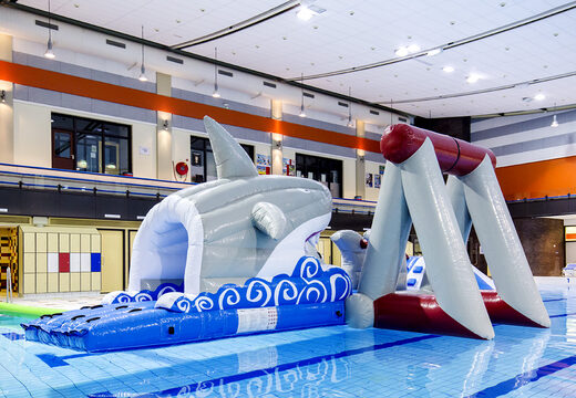 Airtight inflatable shark play island with a vine, climbing tower, round slide and obstacles for both young and old. Order inflatable water attractions now online at JB Inflatables UK
