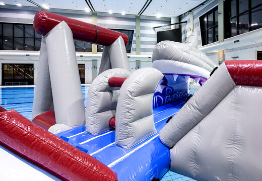 Order an airtight inflatable play island in a shark theme with a liana, climbing tower, round slide and obstacles for both young and old. Buy inflatable pool games now online at JB Inflatables UK