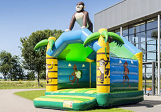 Buy a standard jungle bouncy castle for children in striking colors with a large 3D object in the shape of a gorilla on the top. Order bouncy castles online at JB Inflatables UK