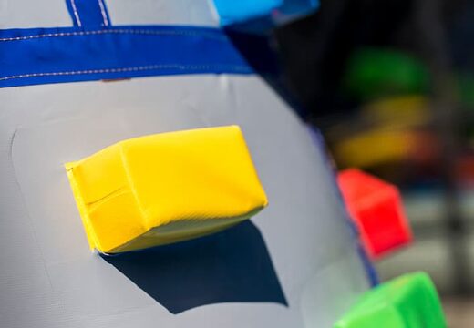 Inflatable covered bouncer in a castle theme with a slide on the jumping surface, climbing tower and fun obstacles for kids. Buy bouncers online at JB Inflatables UK