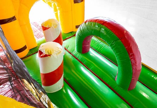 Order Jungleworld bouncy castle in a unique design with two entrances, a slide in the middle and 3D objects for kids. Buy bouncy castles online at JB Inflatables UK