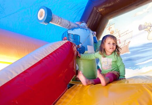 Order shooting combo pirate bounce house covered with cannon game and slide for kids. Buy bounce houses online at JB Inflatables UK