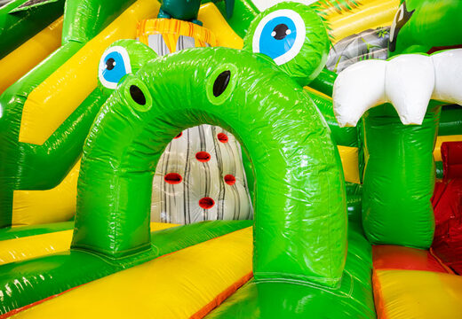 Inside of Slideworld dino green yellow bounce house