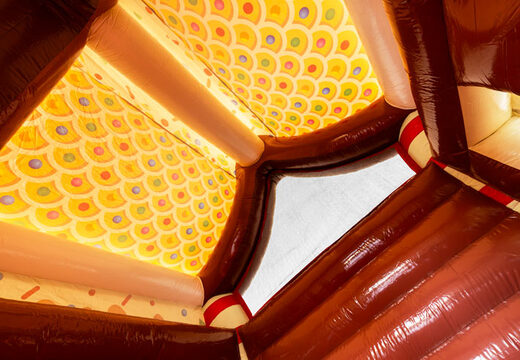 Roof of covered bouncy castle decorated as gingerbread house in gingerbread theme